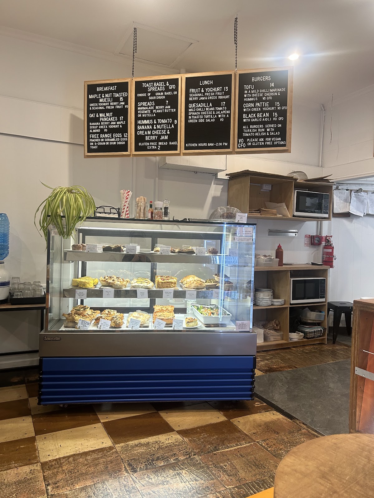 Counter and chalk menu boards inside Pranah Cafe